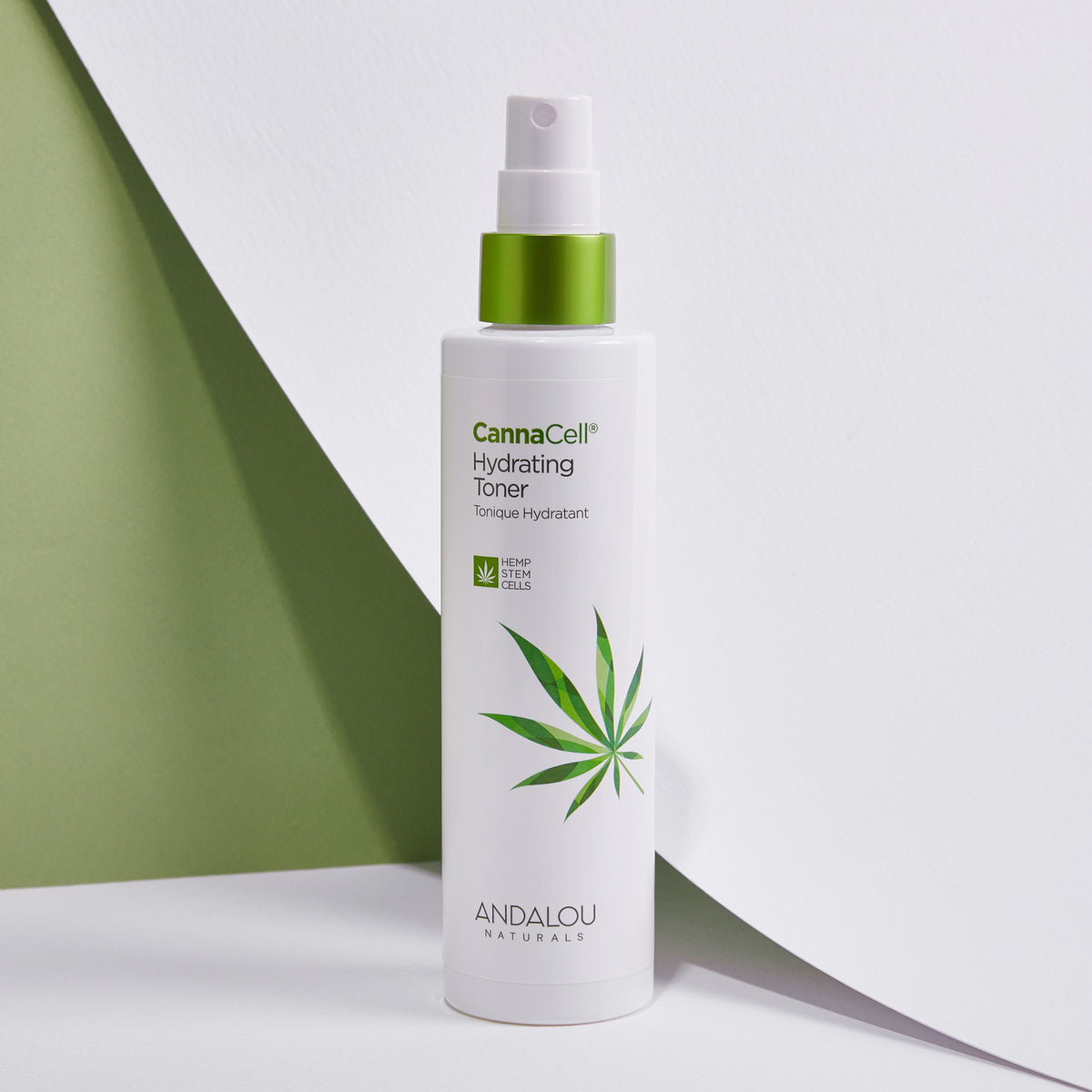A bottle of CannaCell Hydrating Toner from Andalou Naturals against a backdrop of white and green hues.